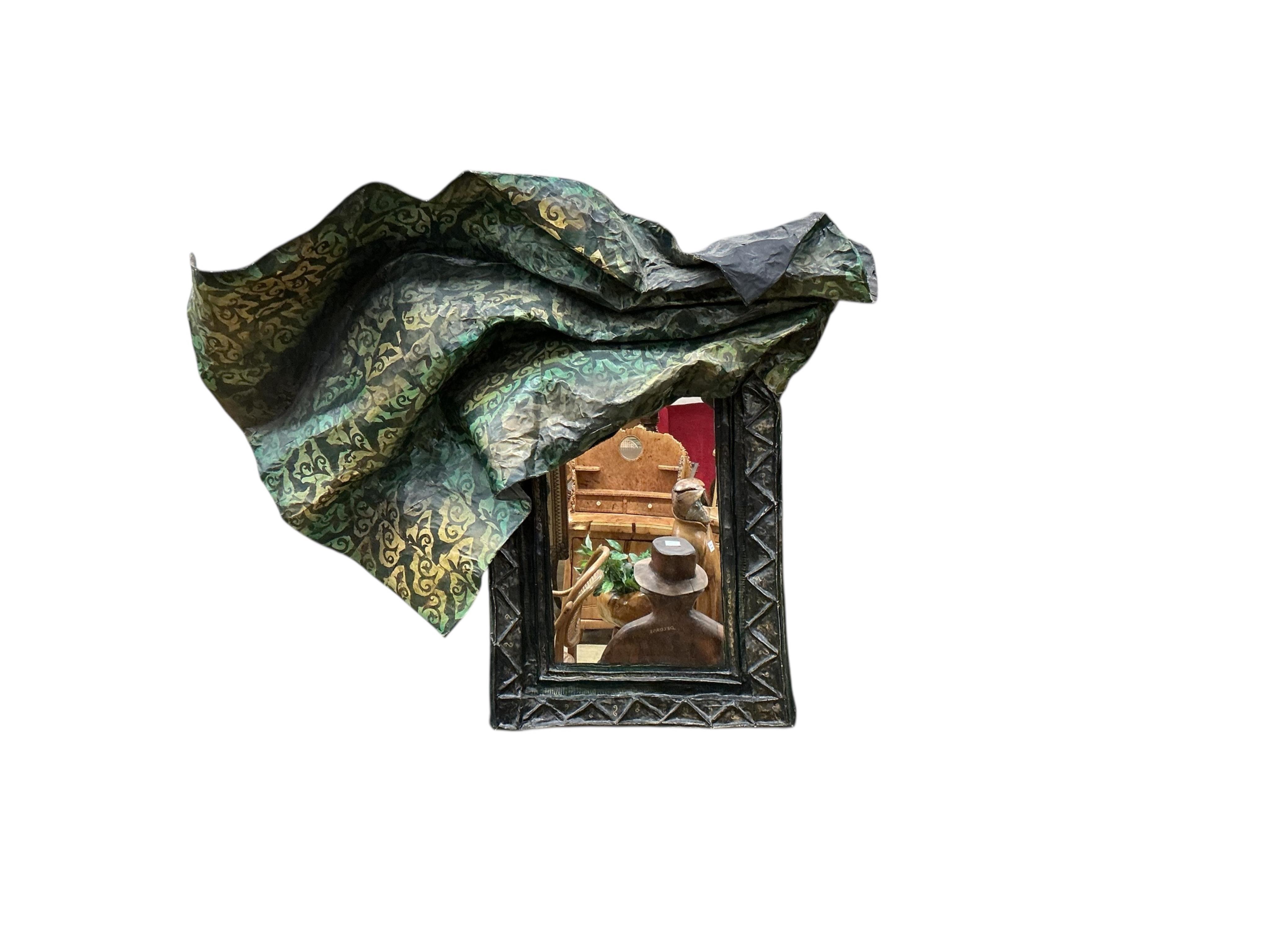 A 20th century papier mache framed mirror modelled as a piece of brocade fabric draped over the rectangular mirror frame, width 120cm, height 102cm